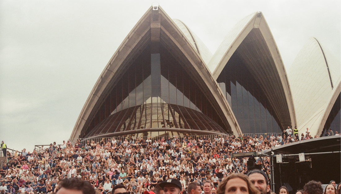 Crowd gathered beneath the sails of the Sydney Opera House