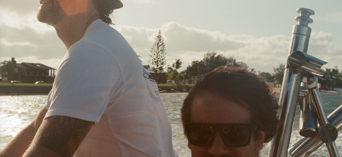 Two mates out on the water in a tinny on a sunny Australian afternoon